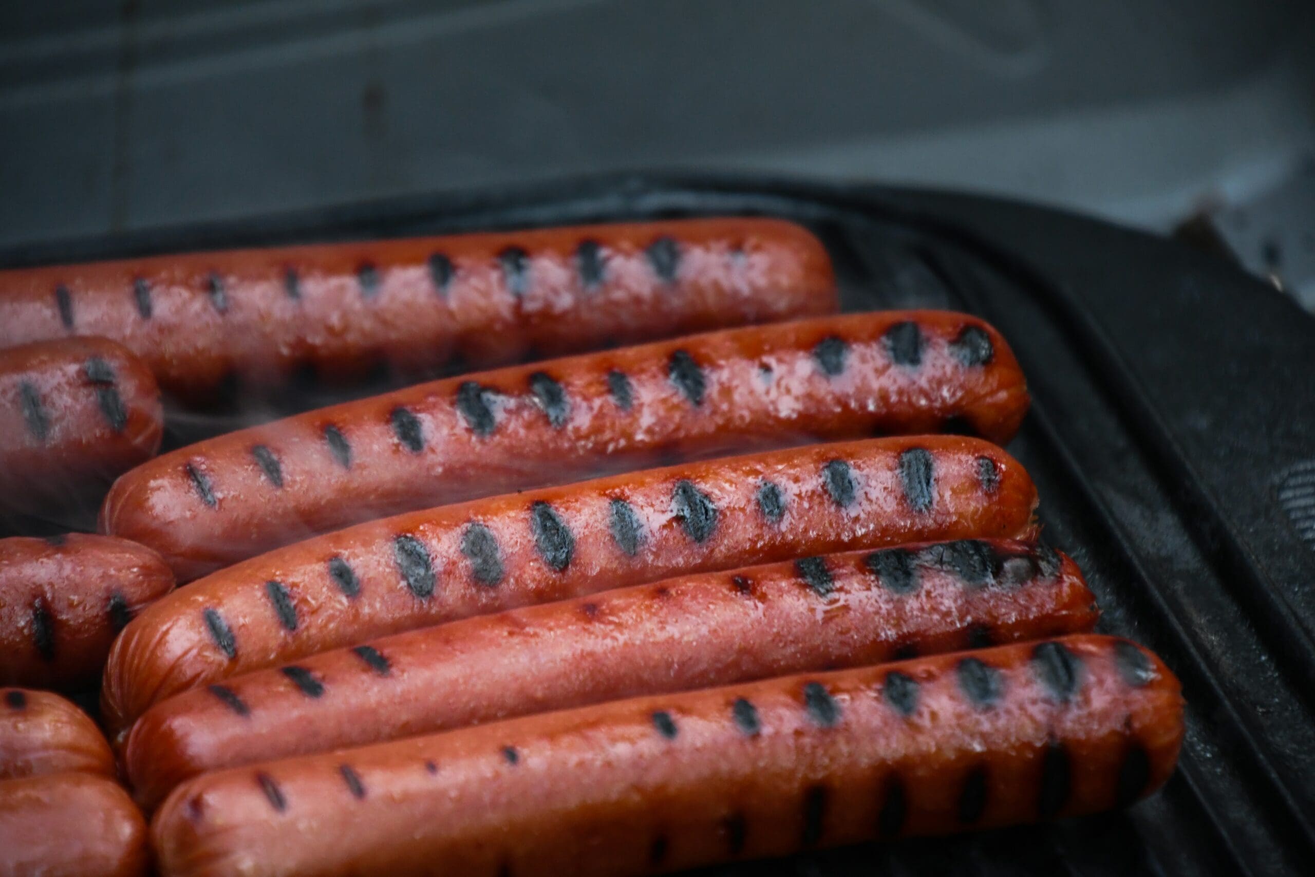 striped hot dogs with grill marks on a cast iron skillet grill pan